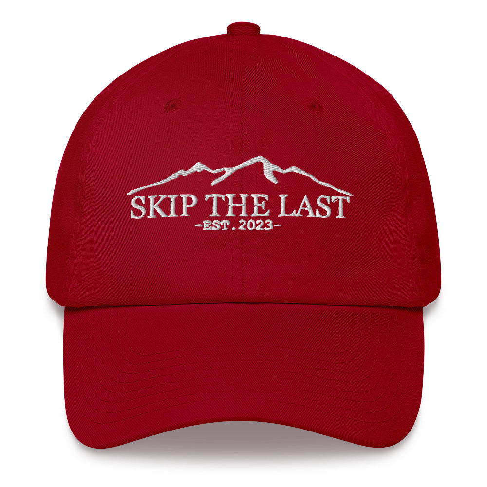 Two More Skip The Last "Skip the Last" cranberry unisex embroidered dad hat. Front view